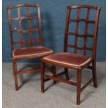 A pair of mahogany open lattice back chairs, with fabric upholstered seats.