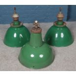 Three industrial green enamel light shades.