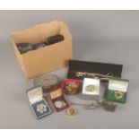 A box of assorted costume jewellery mainly consisting of necklaces and brooches, most boxed.