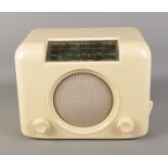 A Bush 1950's bakelite radio in cream. Plug is missing.