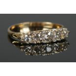 An 18ct Gold carved half hoop five stone old European cut diamond ring. Largest stone Â¼ct. Size