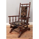 A mahogany child's American rocking chair, with turned bobbin supports and two bobbin stretchers.
