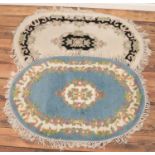 Two small oval rugs with floral design.