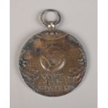 A Dutch white metal footballers medal, enscribed 'Hij Zit' and 'voetbalwedstrijd' (He Sits, Football