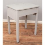 A grey painted wooden desk.