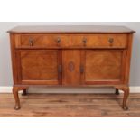 A mahogany sideboard. With carved central motif decoration. (95cm x 137cm)