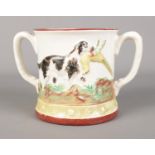 A Staffordshire twin-handled frog mug featuring pheasant hunting decoration.