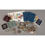 A box of British and world coins, stamps, medals etc.