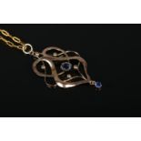 A 9ct Gold nouveau pendant, set with central and droplet blue stones, on 9ct Gold chain. Total