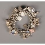 A boxed silver charm bracelet with approx. 45 silver charms. Bracelet hallmarked Birmingham 1961.