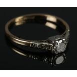 An 18ct gold & platinum diamond solitaire ring. Size L .2.02g.