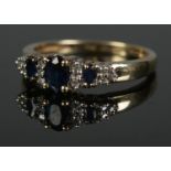 A boxed 9ct diamond and sapphire ring. Size N 21.9g.