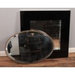 Two mirrors; including brass framed bevel edged and modern square, black glass framed examples.