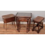 A mahogany nest of three tables along with a sewing box and occasional drop leaf table.