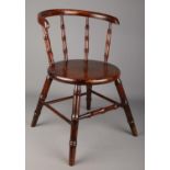 An antique child's arm chair with faux bamboo supports.