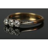 A 18ct gold and platinum three stone diamond ring with box. Size O 2.3g.