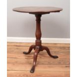 A Georgian oak circular tilt top table, with turned central pillar supported by three cabriole feet.