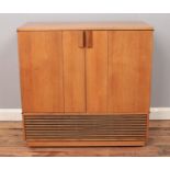 A vintage teak Decca Colour TV cabinet with folding hinged doors, on casters. Height: 78cm, Width: