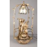 A modern gilt figural water feature table lamp, depicting two water carriers. 70cm high. In