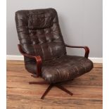 A bentwood easy chair with leather upholstery and metal base.