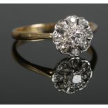 A mid twentieth century 18ct Gold and Platinum Diamond cluster ring, with central brilliant cut