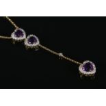 A diamond heart shaped drop-pendant necklace, set with three amethyst coloured stones, on 18ct