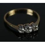 An antique 18ct gold and platinum diamond three stone ring. Size P. 2.06g