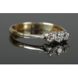 An 18ct Gold and Platinum three stone diamond ring. Size S. Total weight: 2.82g No hallmarks,
