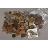 A box of British coins. Includes sixpences, threepences, five pound coins, 1788 token etc.