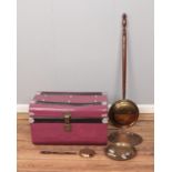 A large purple tin trunk along with assorted metal wares such as warming pan and decorative trays.