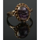 A 9ct gold ring set with a Blue John cabochon stone. Size O. 2.09g.