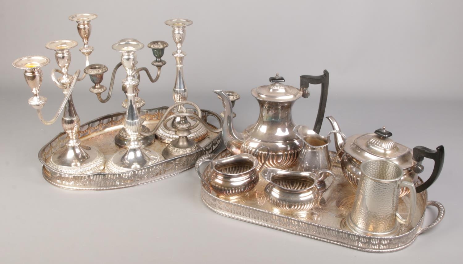 A good collection of silver plate. Includes two gallery serving trays, candelabra, Viners tea set