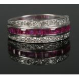 An 18ct White Gold channel set ruby and diamond ring. Size MÂ½. Total weight: 6.22g