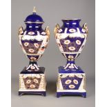 A near pair of large Cottage Derby urns, having the Imari pallet; one with lid. Bears orange crown