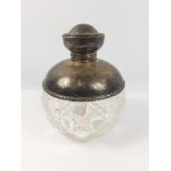 A large cut glass perfume bottle with glass stopper and silver hallmarked top, Chester 1912,