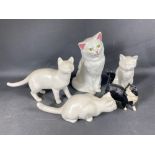 A collection of four white cats (9-26cm high) plus a smaller ROYAL DOULTON black and white cat