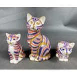 Three ROYAL CROWN DERBY cats one sitting down with gold button (9cm long), and 2 silver button