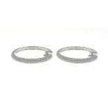 18K 750 stamped white gold and diamond half-hoop earrings, 2.25cm diameter, gross weight 6.52g,