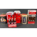 A collection of COCA-COLA dispensers to include model CC28469 which collects 1 cent coins and