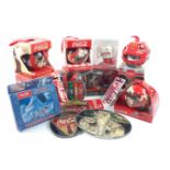 A selection of COCA-COLA themed Christmas decorations to include 3 snow globes, a boxed Santa mug