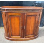 A fabulous oval bull-nose' drinks cabinet