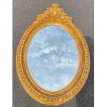 Large oval wall mirror with gilt wooden frame
