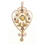 A 9ct stamped yellow gold openwork pendant set with green peridot and seed pearls (1 missing) 4cm