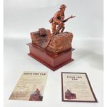 An OVER THE TOP Danbury Mint bronzed sculpture on a wooden plinth includes a penny from 1918,