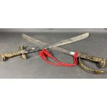 DECORATIVE ! A pair of reproduction swords with brass handles