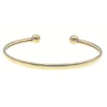 A 375 stamped yellow gold open bangle width 6.5cm approx weight 6.89g approx