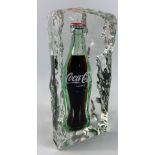 A COCA-COLA bottle encased in an acrylic iceberg, standing approx 24cm tall