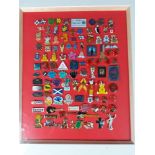 A framed collection of pin badges to include Corgi , Land Rover , Red Nose Day , Team GB , RNLI