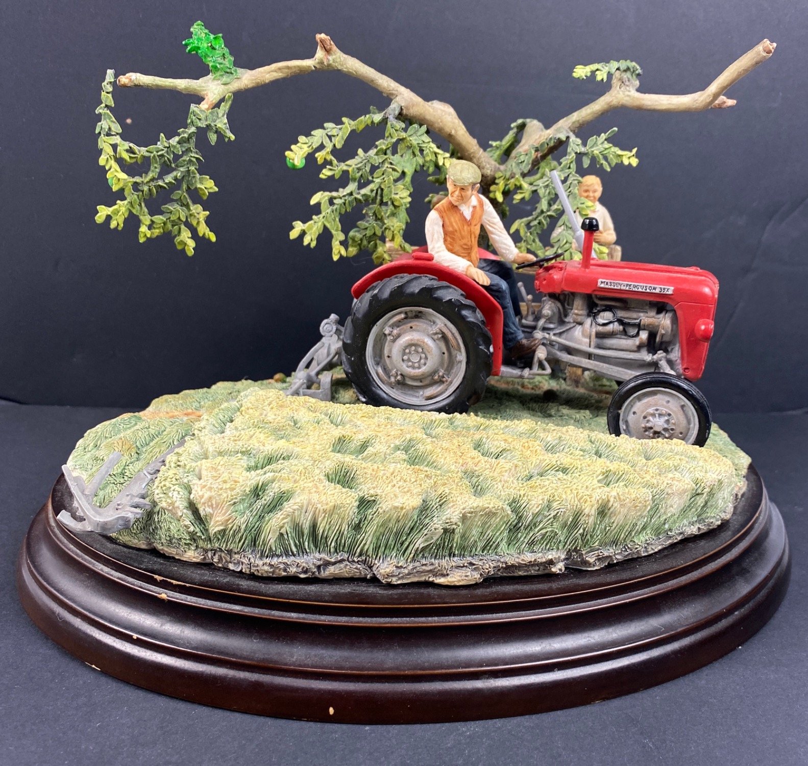 A decorative 'Country Artists' 'Summer's First Cut' scene on stand