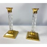 A pair of WATERFORD crystal and brass candlesticks standing 28cm tall